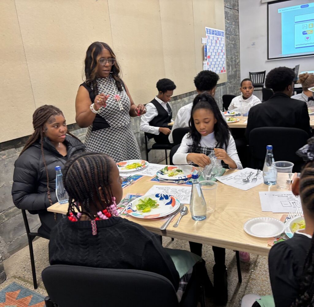 Students practicing table settings during the etiquette class