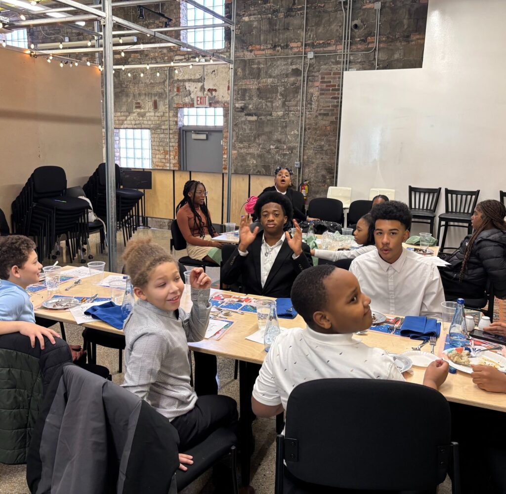 Students at the etiquette class dining table